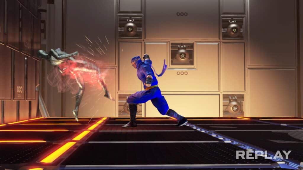 Virtua Fighter 5 REVOのスクリーンショット。金属製のアリーナ内でファイターが相手を壁に叩きつける様子が映っている。