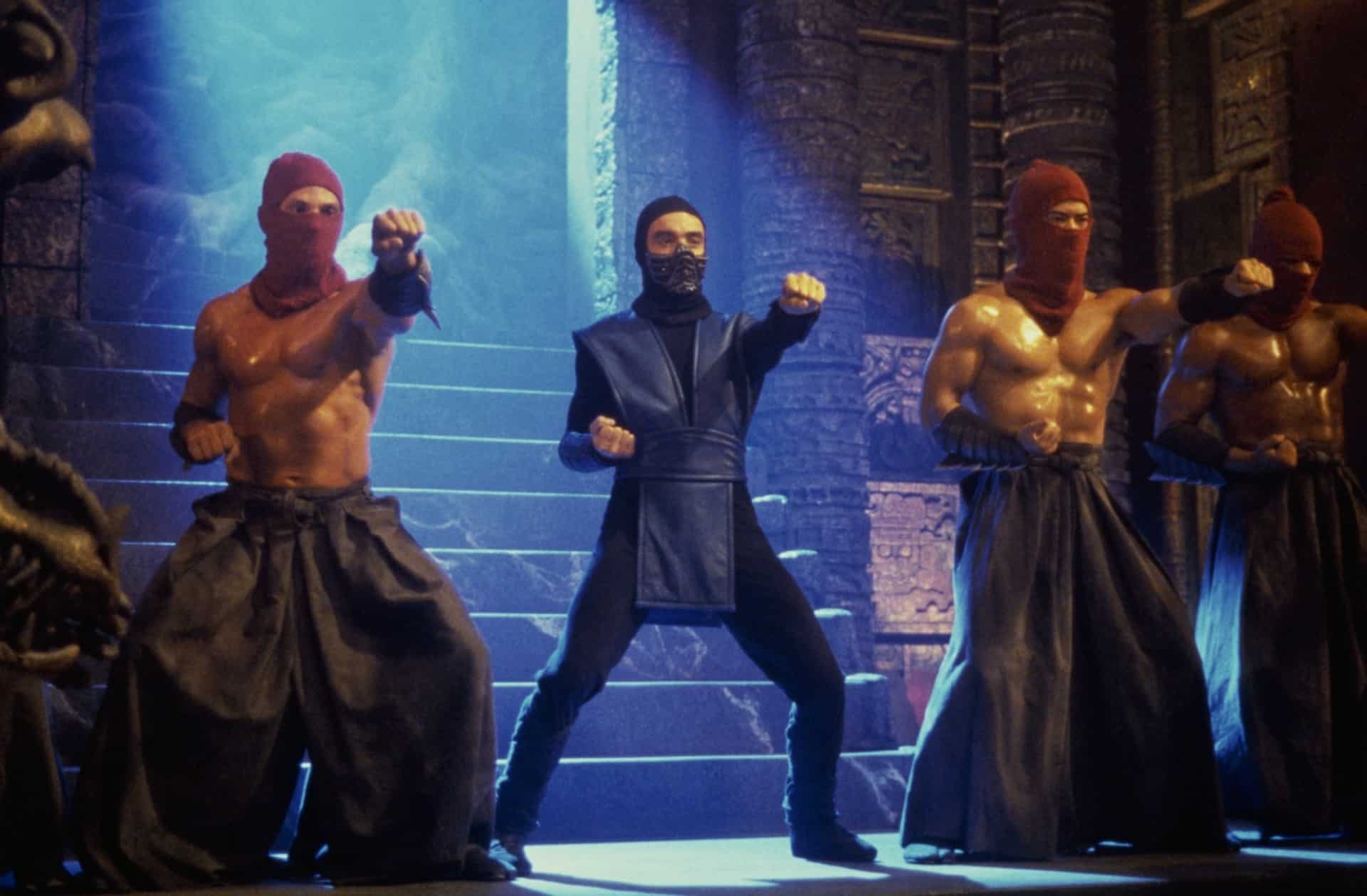 Live action Sub-Zero striking a martial arts pose with three other men.