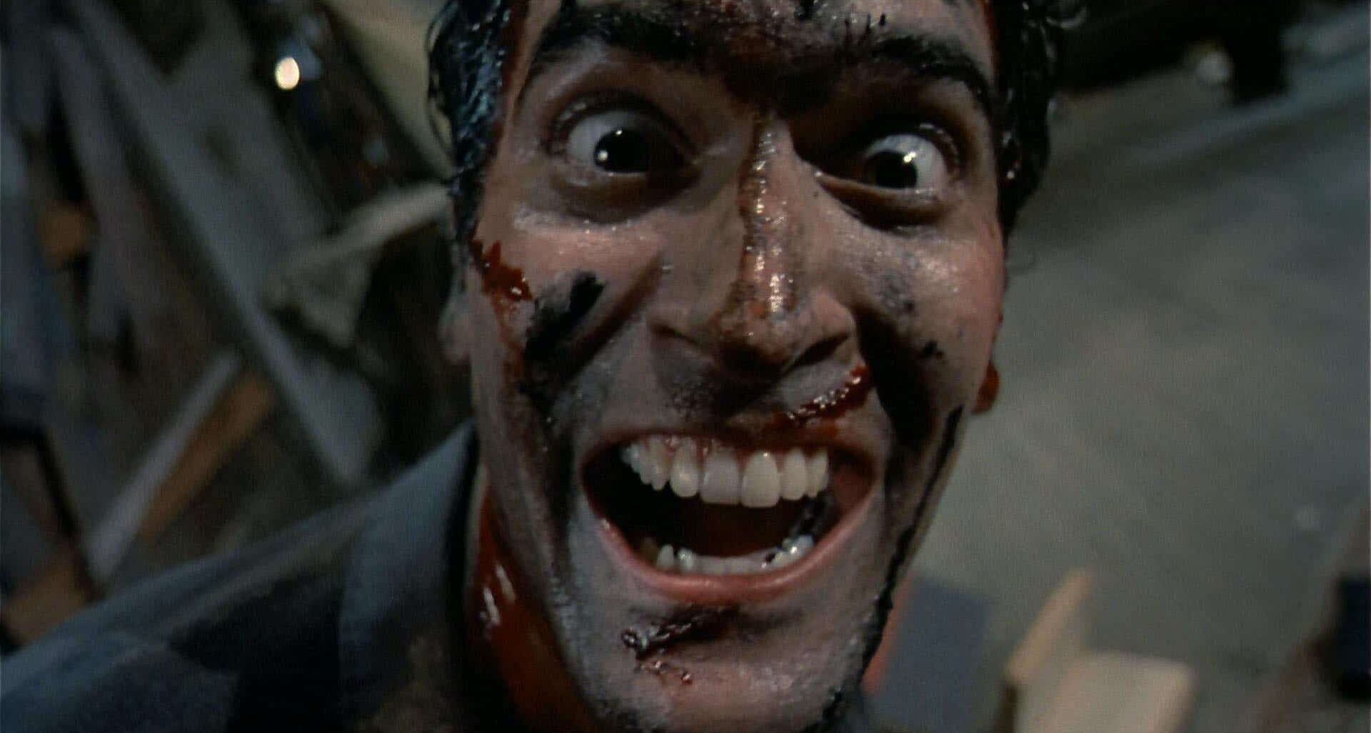 Image of a man with blood on his face staring with a crazed expression