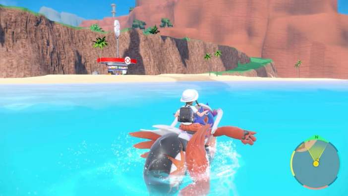 Player riding Koraidon on water in Pokemon Scarlet and Violet - Best Water Type Pokémon in Scarlet and Violet