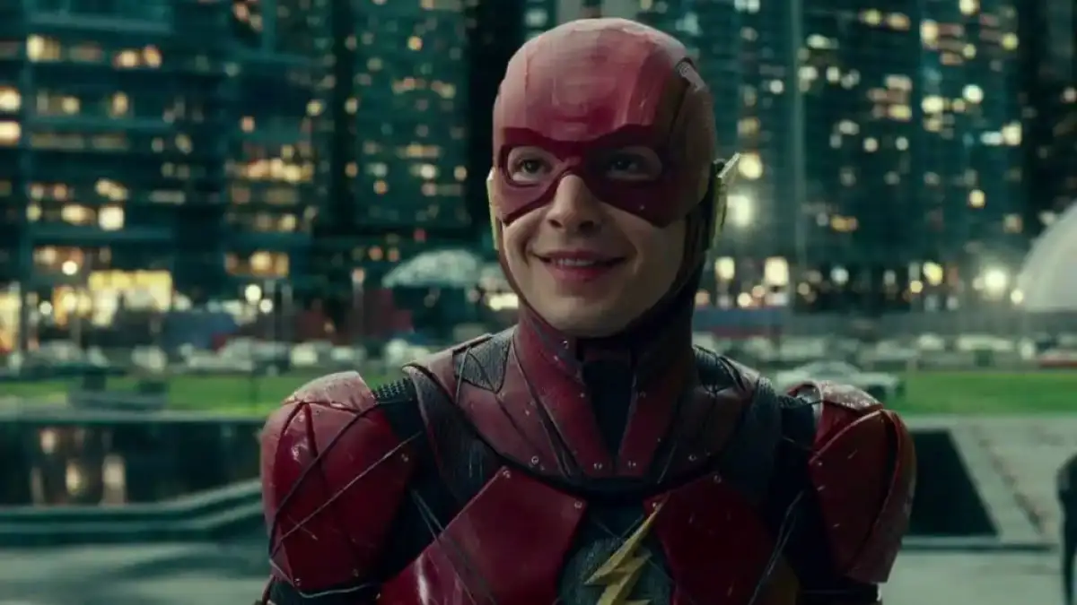 The Flash smiling. This image is part of an article about all the DCEU movies ranked.