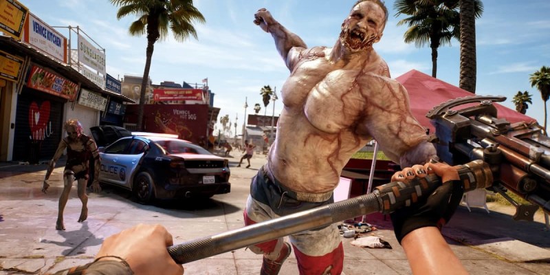Does Dead Island 2 Have a Photo Mode Featured Image - A Brawny Zombie leaps towards the screen, where the character, in first-person view, holds out a weapon.