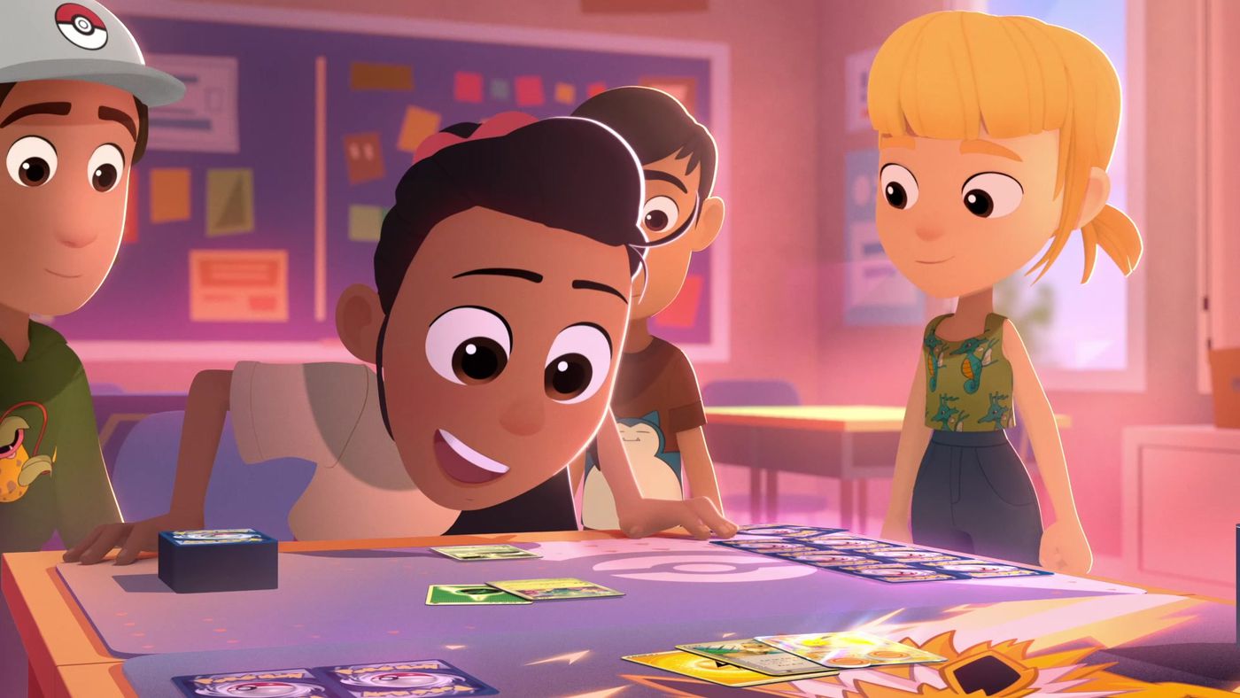 A young person from Pokémon Presents looks at Pokémon cards on a table.