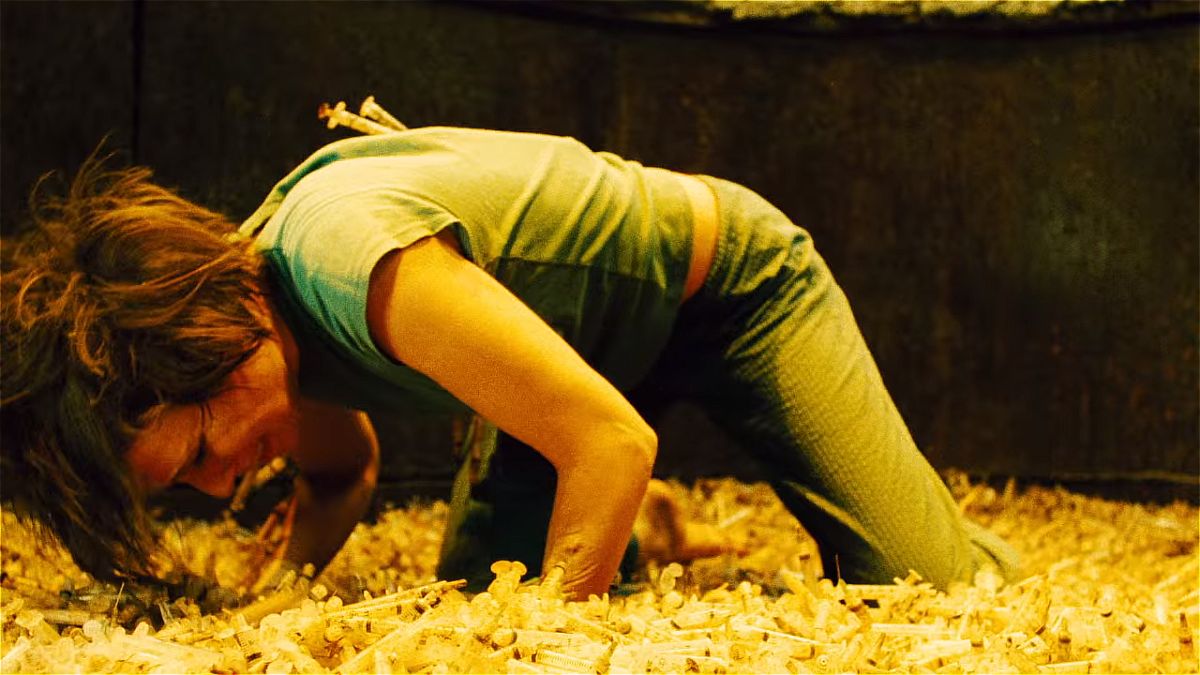 The needle pit is one of the best traps from the Saw movie franchise. The image shows the character Amanda digging in a vast pit of needles.