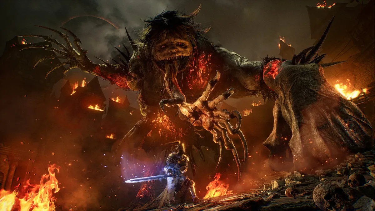 Knight fighting a massive creature in a burning village in Lords of the Fallen.