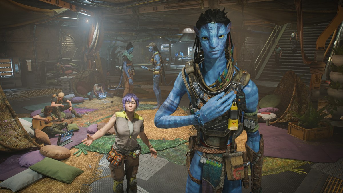 Image from Avatar: Frontiers of Pandora as part of a preview of the upcoming Ubisoft game. The image shows a Navi and a much smaller woman looking at the player while other people putter around in the background.