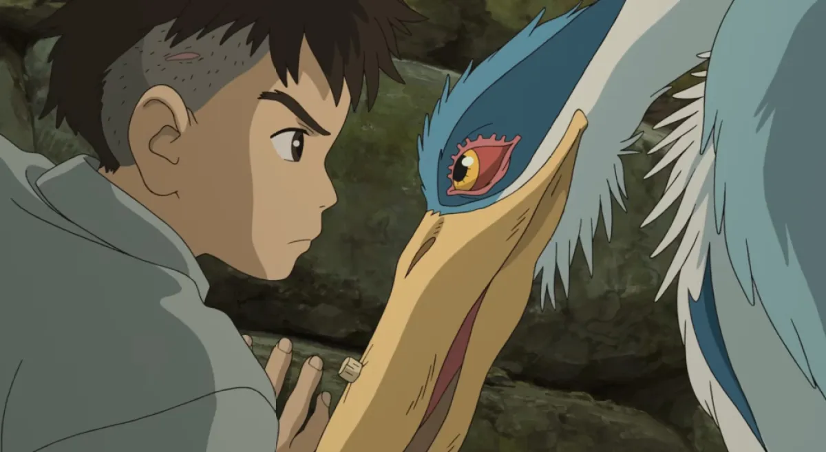 The Boy and the Heron English Trailer Reveals Stunning Performances Robert Pattinson Grey Heron. This image is part of an article about the best animated movies of 2023.