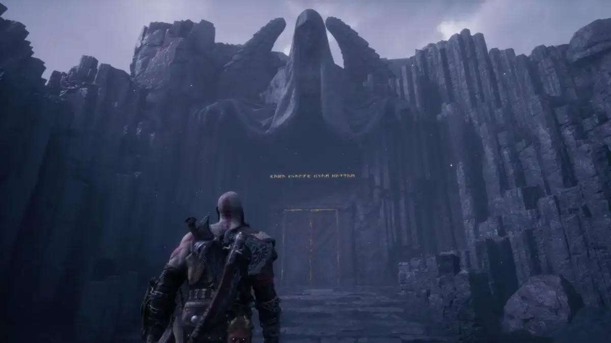 Image of a bald man with ashy skin and an axe on his back gazing up at an angel statue in God of War Ragnarok Valhalla DLC.