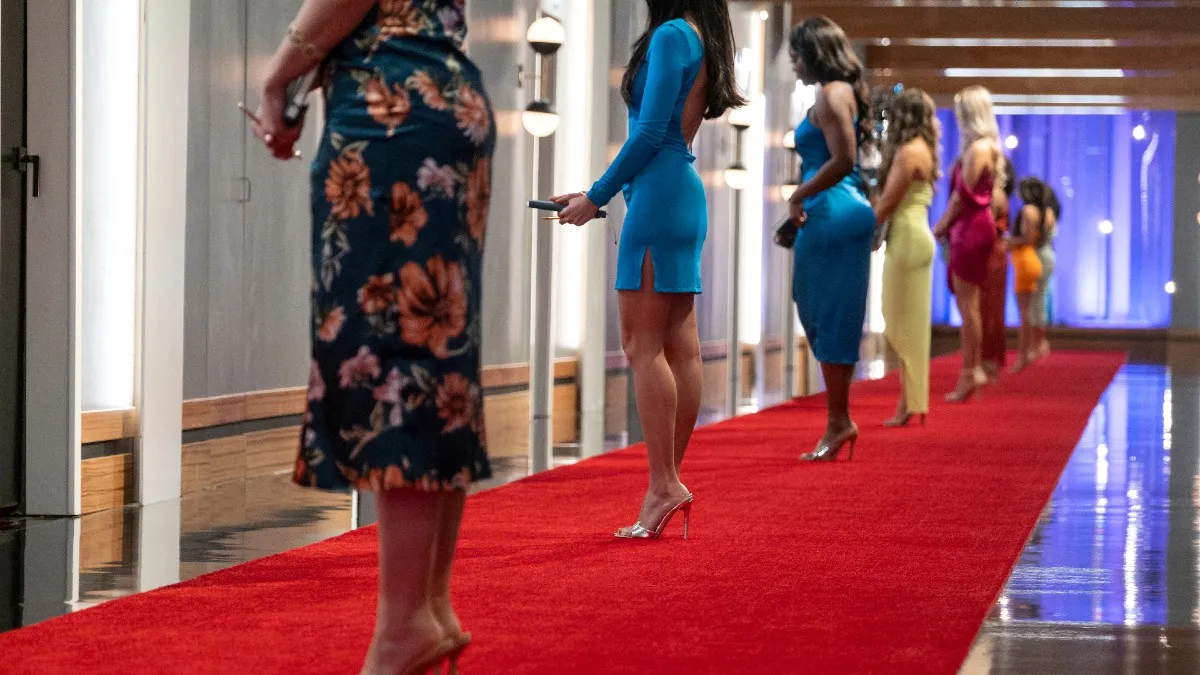 Women standing on a red carpet. This image is part of an article about where Love Is Blind Season 6 was filmed.