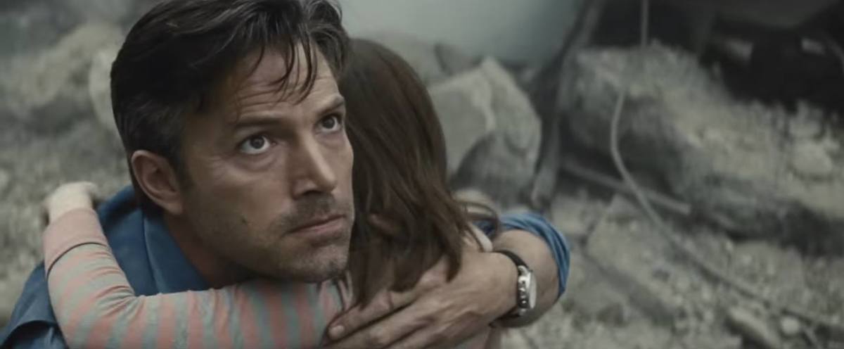 Bruce Wayne staring off. This image is part of an article about how the MonsterVerse is doing what the Snyderverse couldn't.