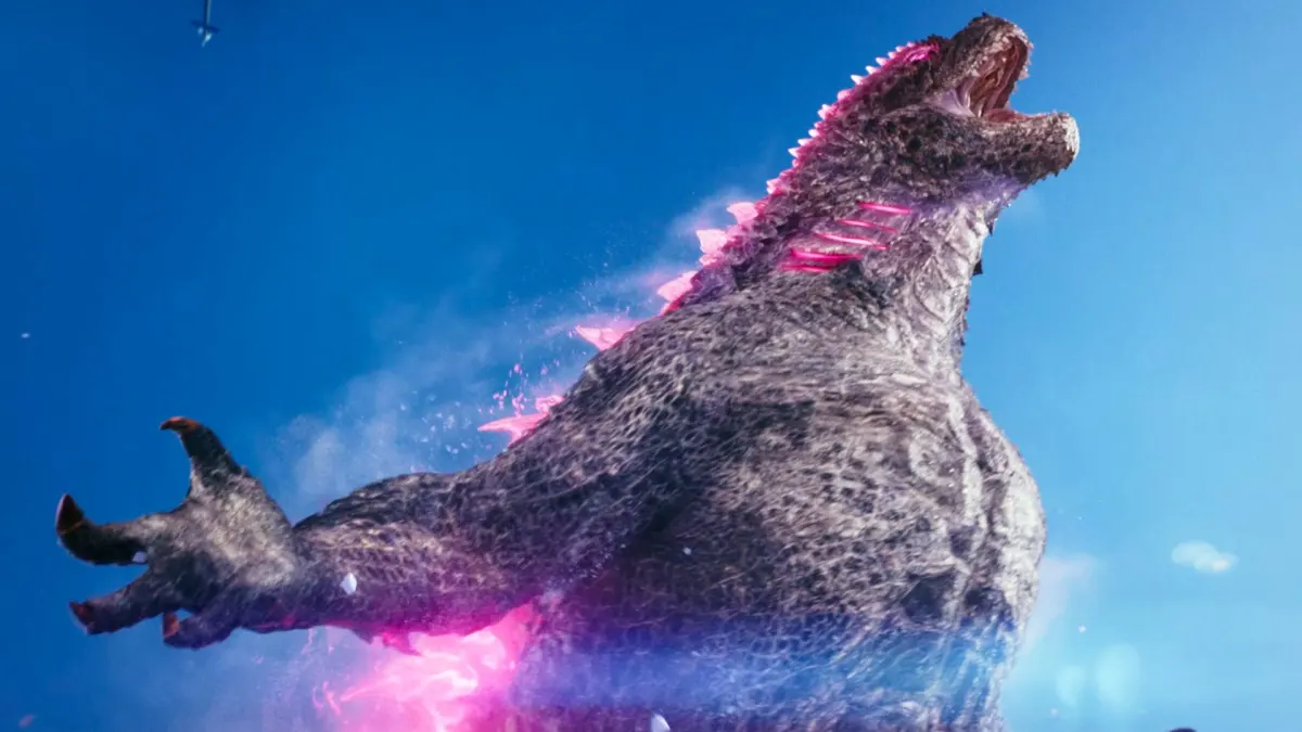 Pink Godzilla emerges from ice roaring. This image is part of an article about why Godzilla is pink in the New Empire trailer.