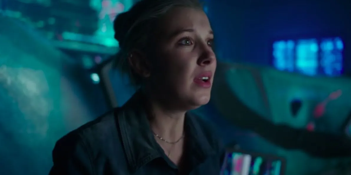 Millie Bobbie Brown in Godzilla. This image is part of an article about how the MonsterVerse is doing what the Snyderverse couldn't.