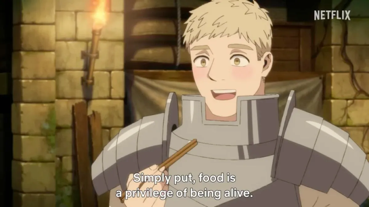 An official image of Laios showing him talking about food. He wears a knight's armor. The image is part of an article on all the English dub actors and cast list for Delicious in Dungeon.