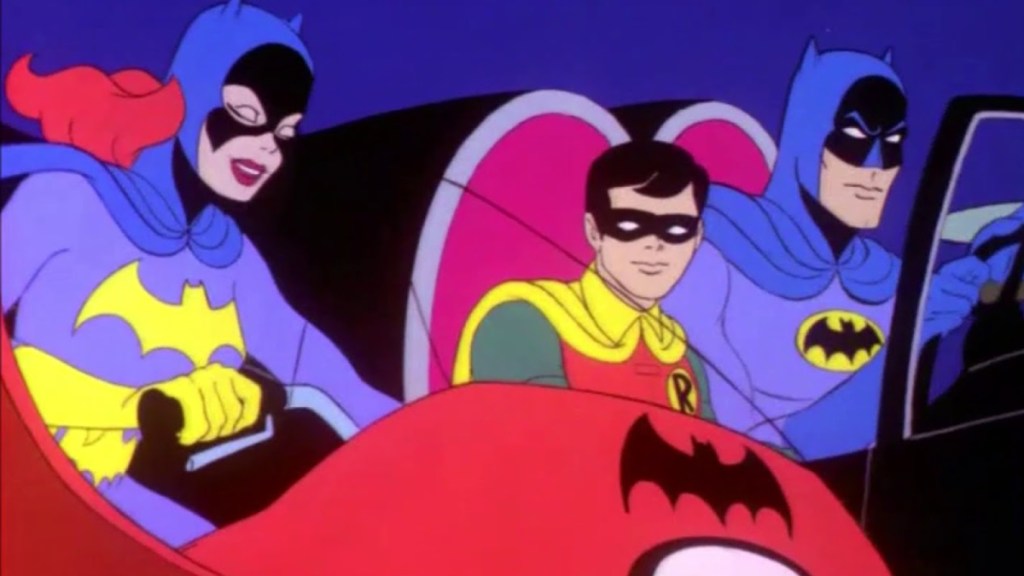 Bruce Wayne, Robin and Batgirl driving.