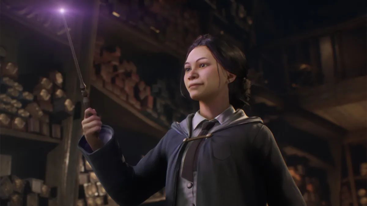 A girl holding up a glowing wand.