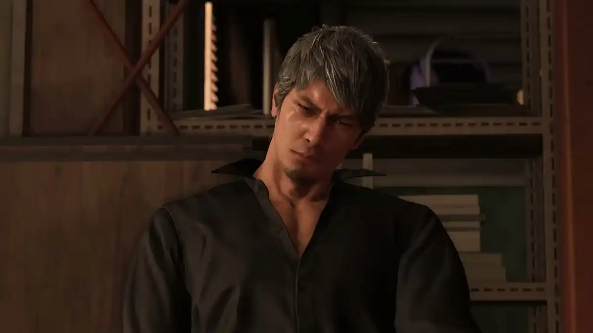 Like a Dragon: Infinite Wealth's Kazuma Kiryu, with dyed white hair sitting on a couch.