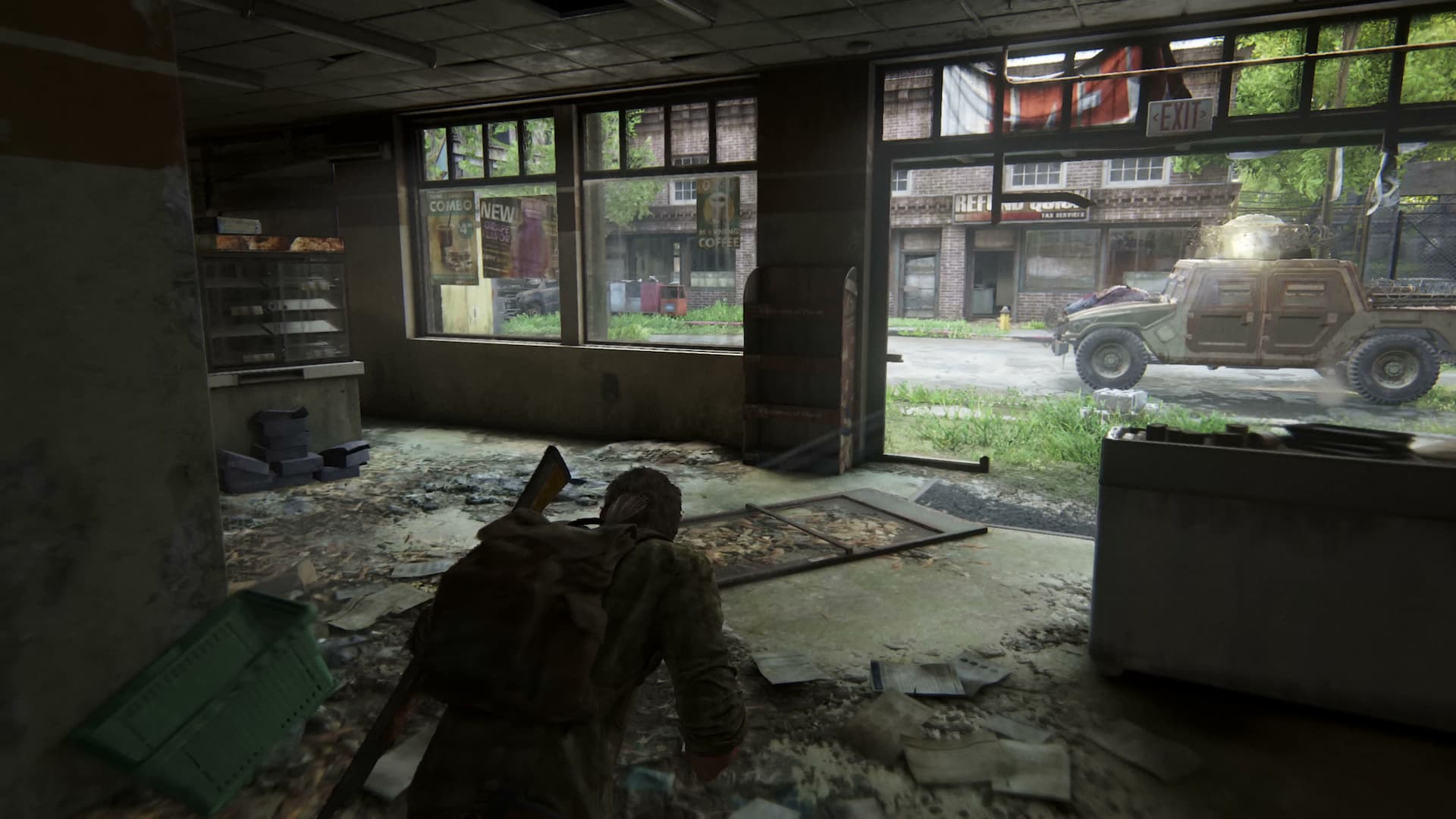 The Last of Us, with Joel, a man in a flannel shirt, creeping towards an armored car.