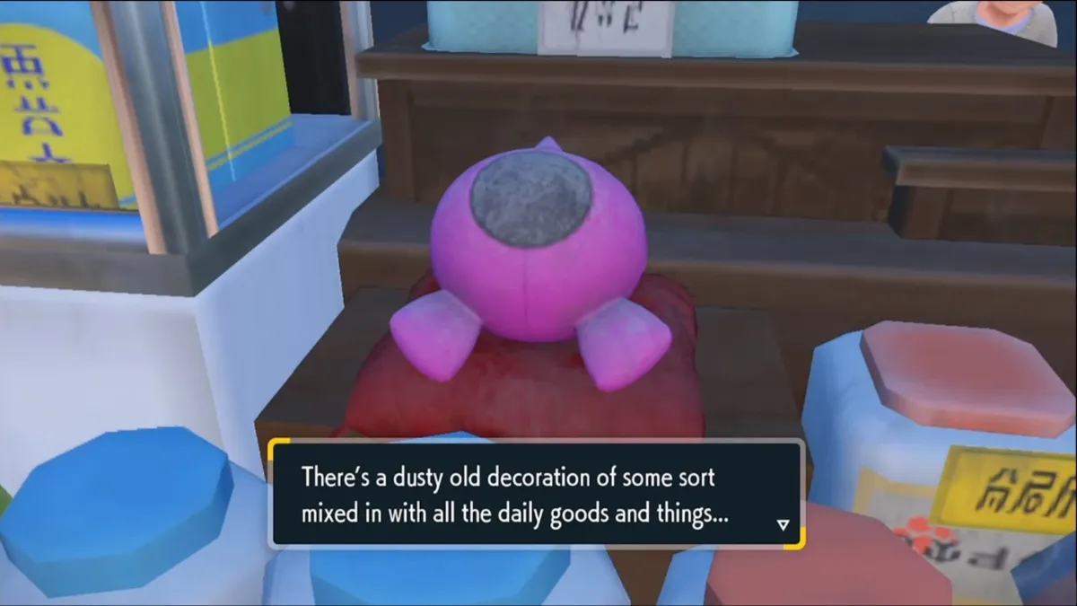Pokemon Scarlet and Violet screenshot of the Mochi Mayhem epilogue's dusty old Pecharunt decoration at the store kiosk in the Kitakami region