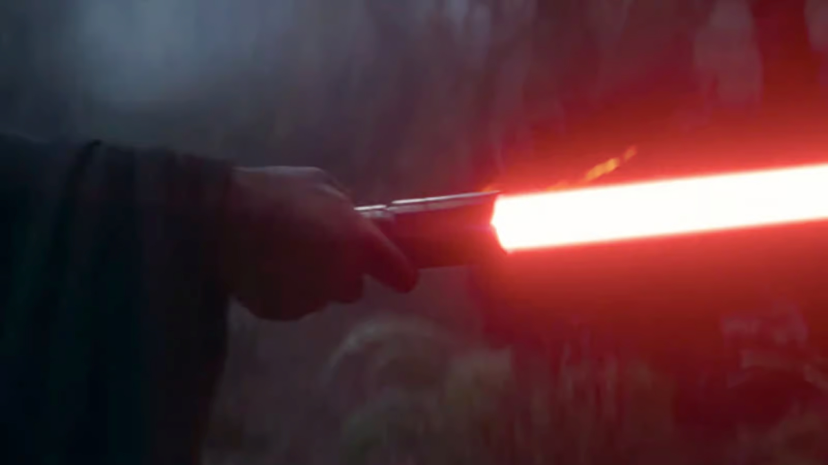 A Sith Lord's hand gripping a red lightsaber in Disney+ Star Wars series The Acolyte