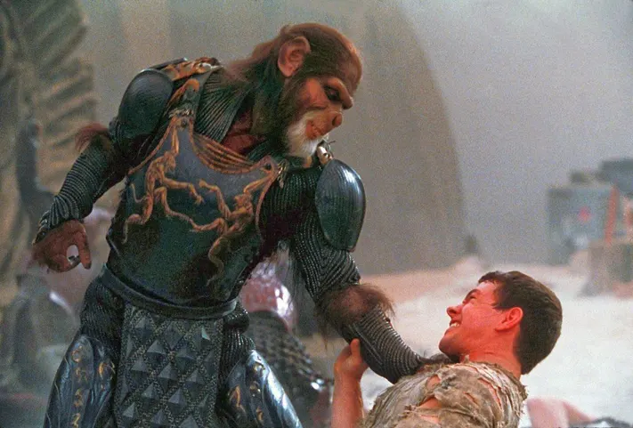 An ape strangling a man in Planet of the Apes. This image is part of an article about every Planet of the Apes movie, ranked from worst to best.