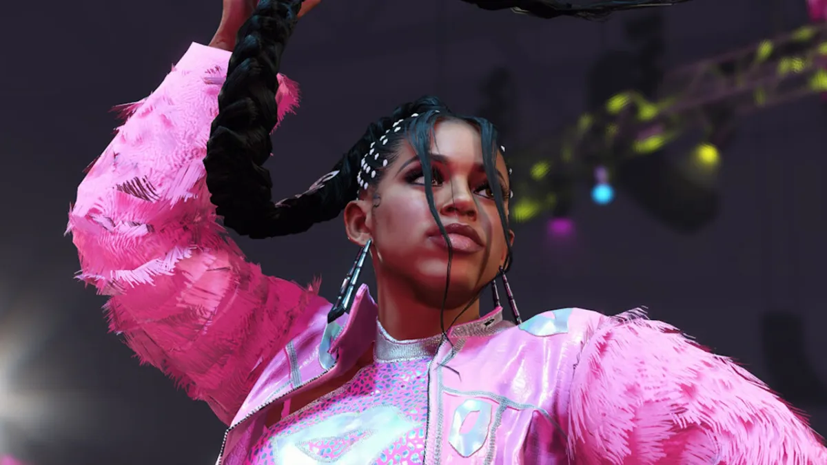 A wrestler dressed in pink, raising her right arm, in WWE 2K24.