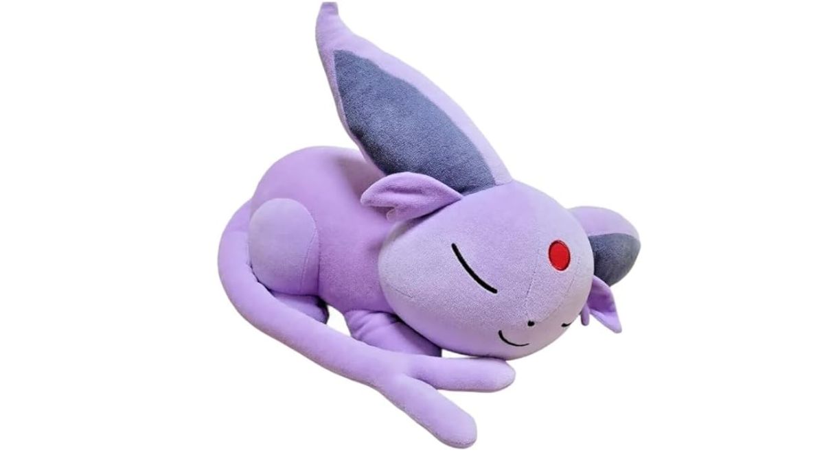 Photo of an Espeon plush, curled up and sleeping