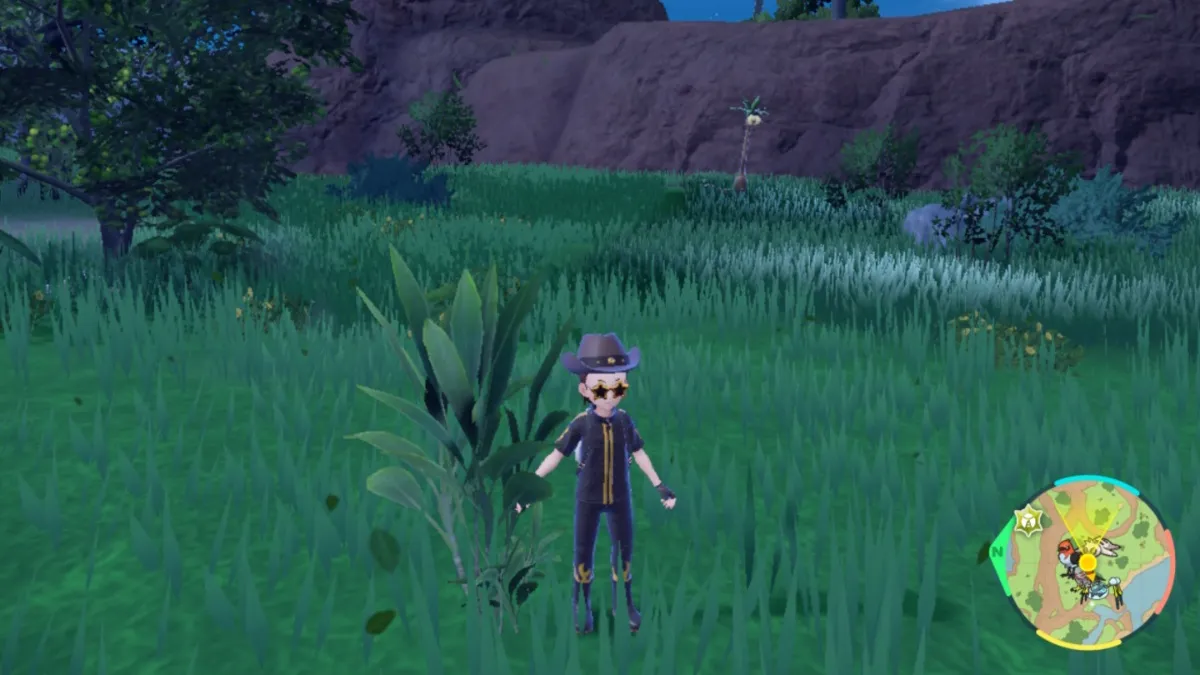 Pokemon Scarlet and Violet screenshot of the player character standing beside a tall leafy plant in the Blueberry Academy's Coastal Biome.