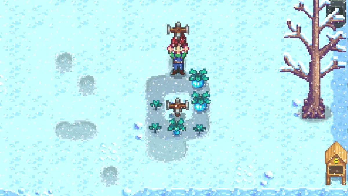 Screenshot of a farm in Stardew Valley, with a player character holding a sprinkler over their head