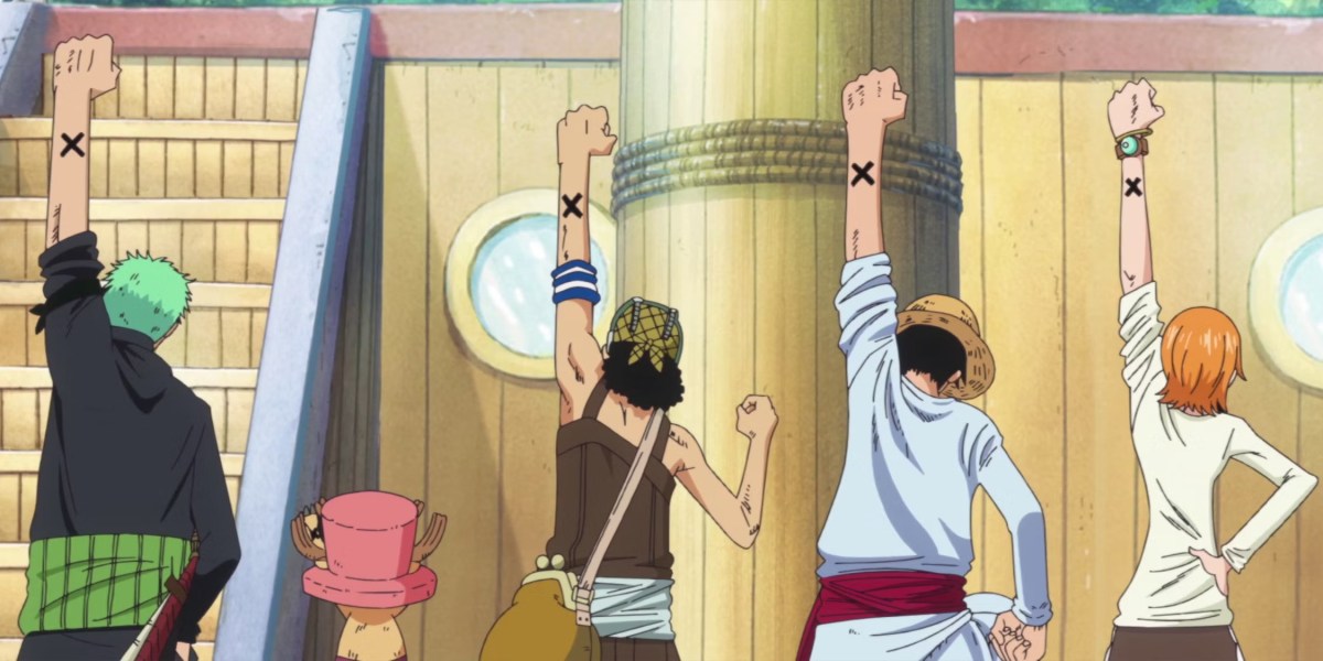 Straw Hats holding their X tattoos in the air.