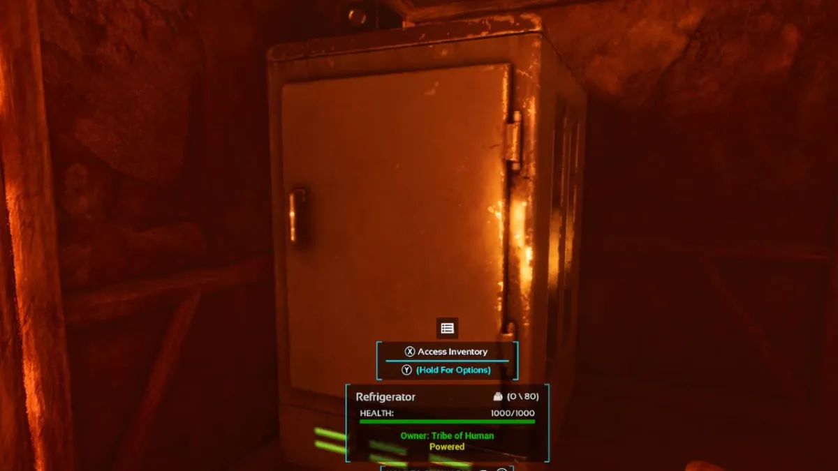 A fridge, bathed in red, in Ark: Survival Ascended, as part of an article on how to get rid of heat stroke in the game.