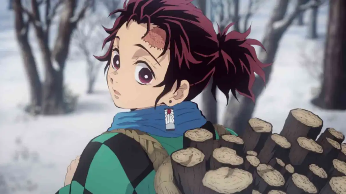 Tanjiro gathers wood in the snow. This image is part of an article about all Demon Slayer seasons ranked from worst to best.
