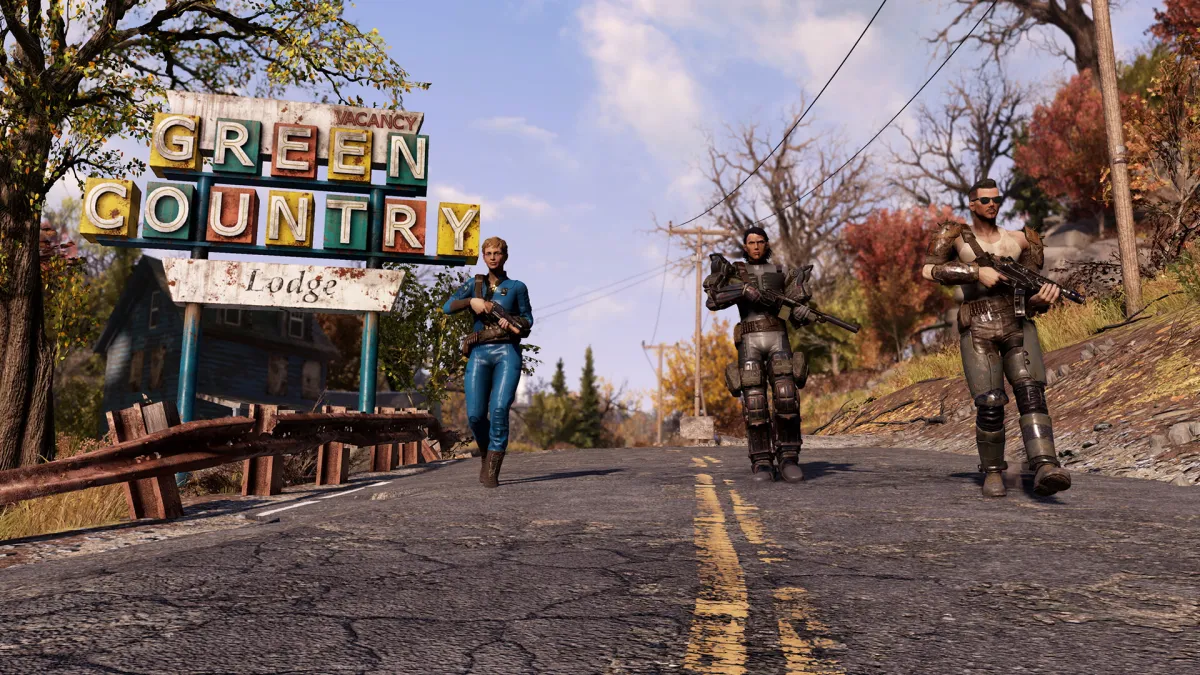 Fallout 76, with the people walking along a road with trees on either side.