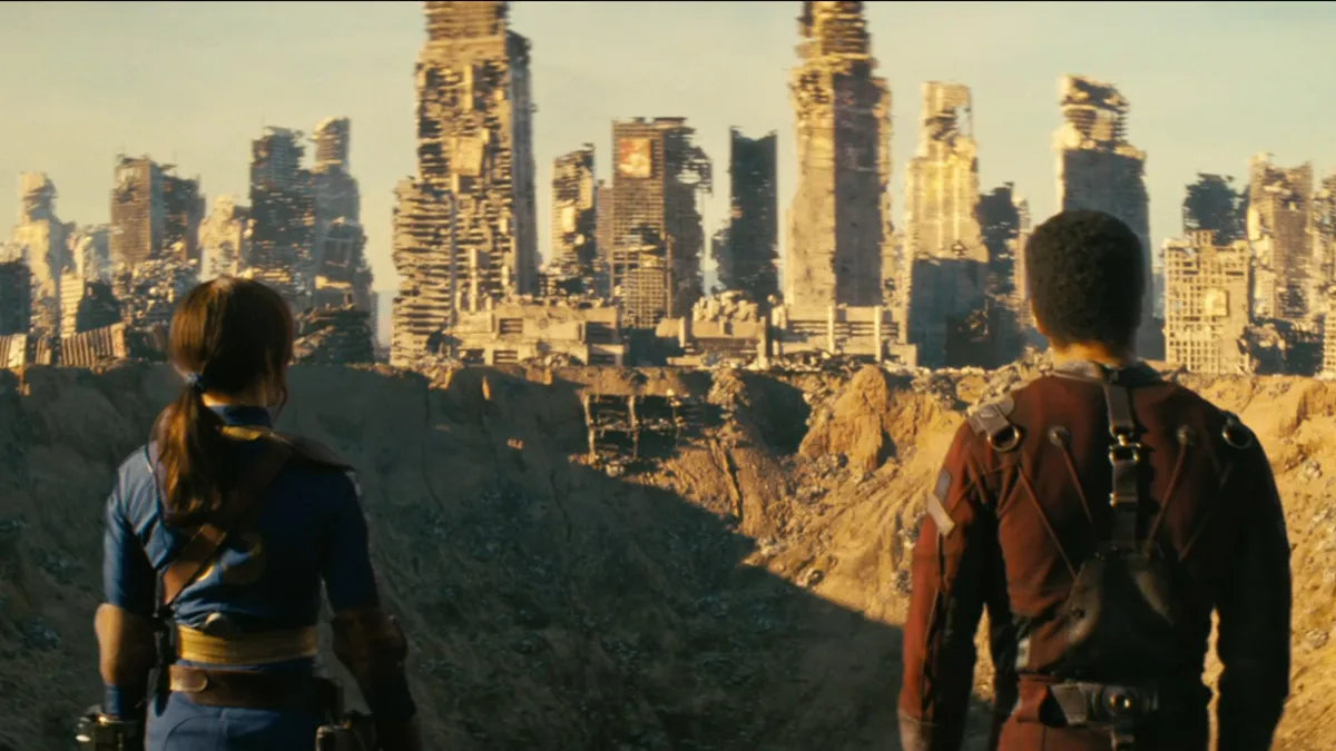 Two people looking out a devastated city and a massive crater in Amazon's Fallout series.