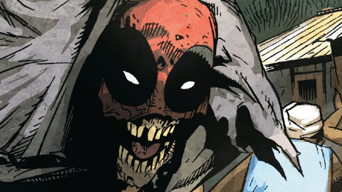 The zombified head of Deadpool, an undead face in a red mask. 