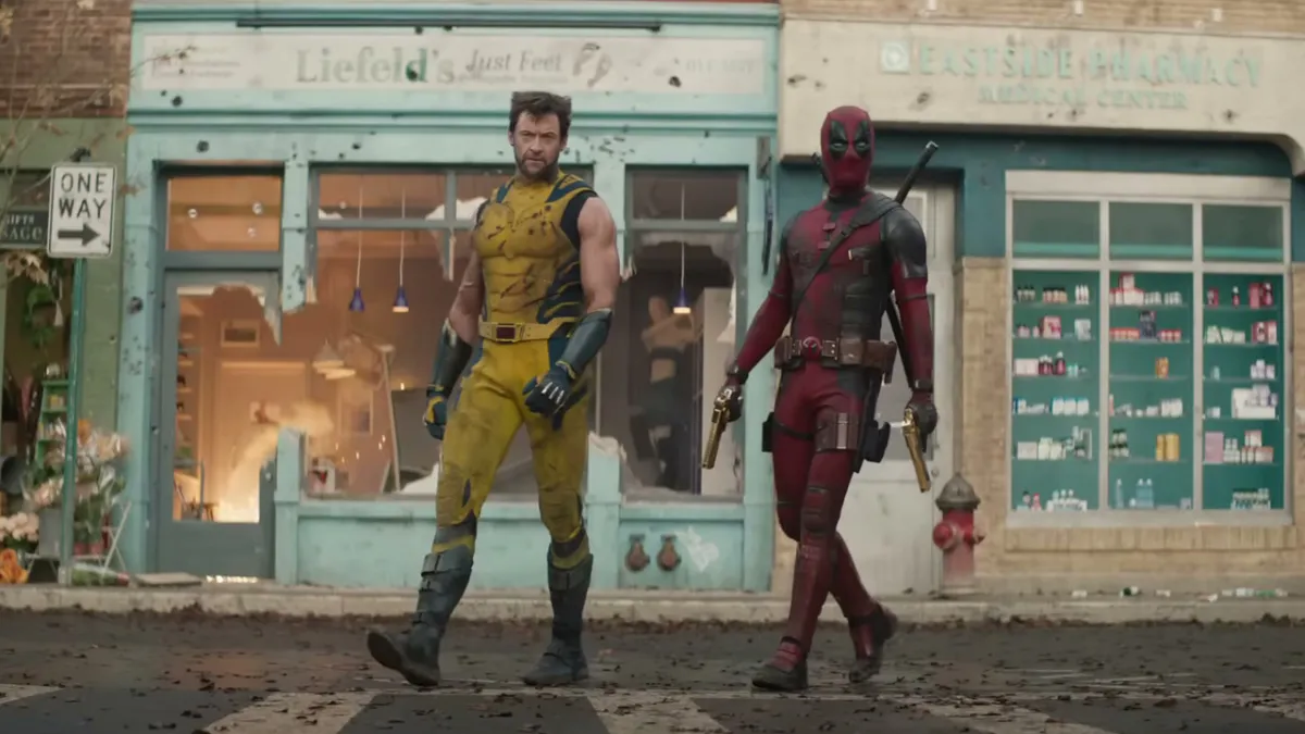 Deadpool and Wolverine in a street, in front of a store that says Liefeld's Just Feet. 