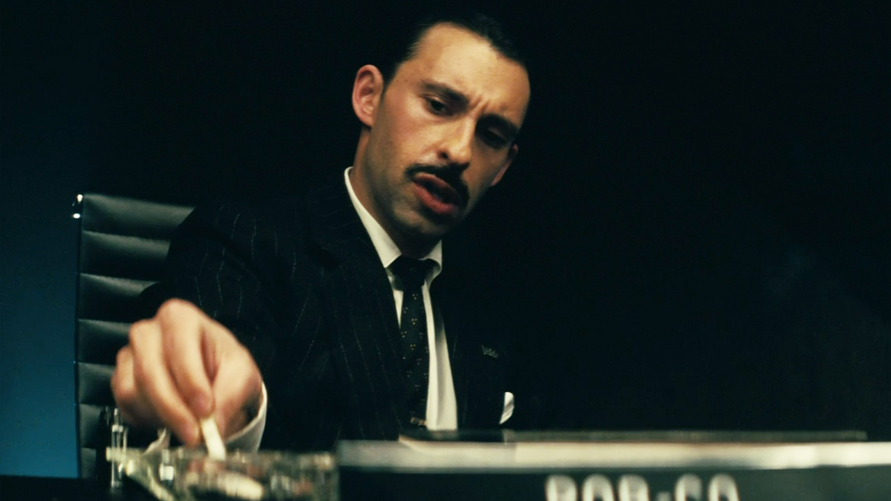 The Fallout series, a man in a suit and thin moustache stubbing a cigarette. 