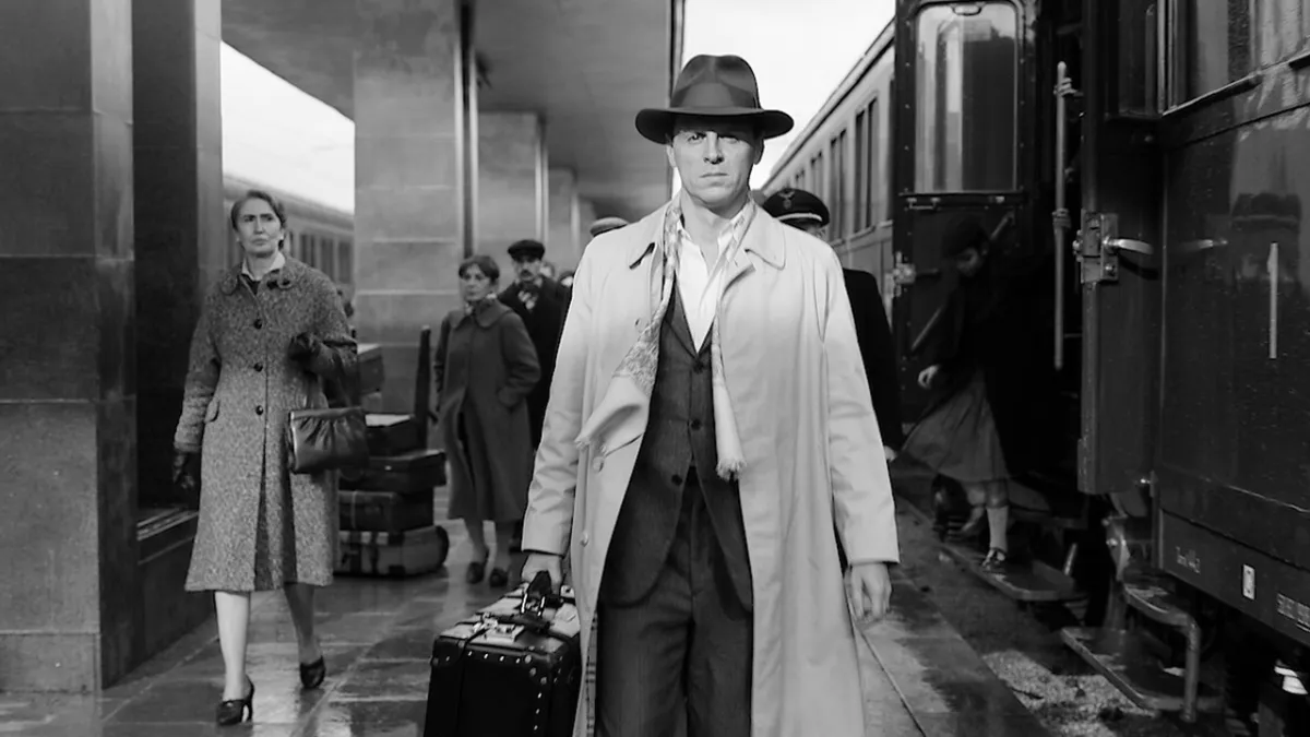 Tom Ripley, played by Andrew Scott, walking down a railway platform.