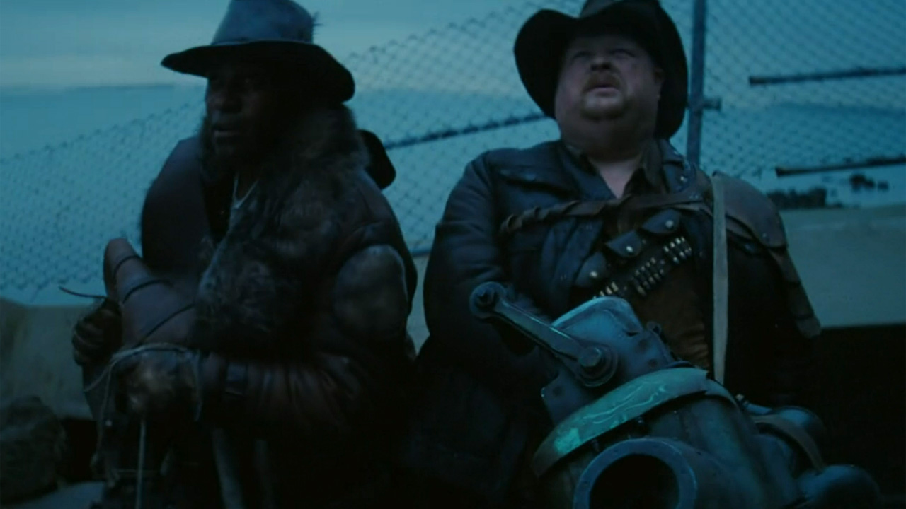 The Fallout TV series, with two men, one holding a Rock-It Launcher style cannon. 