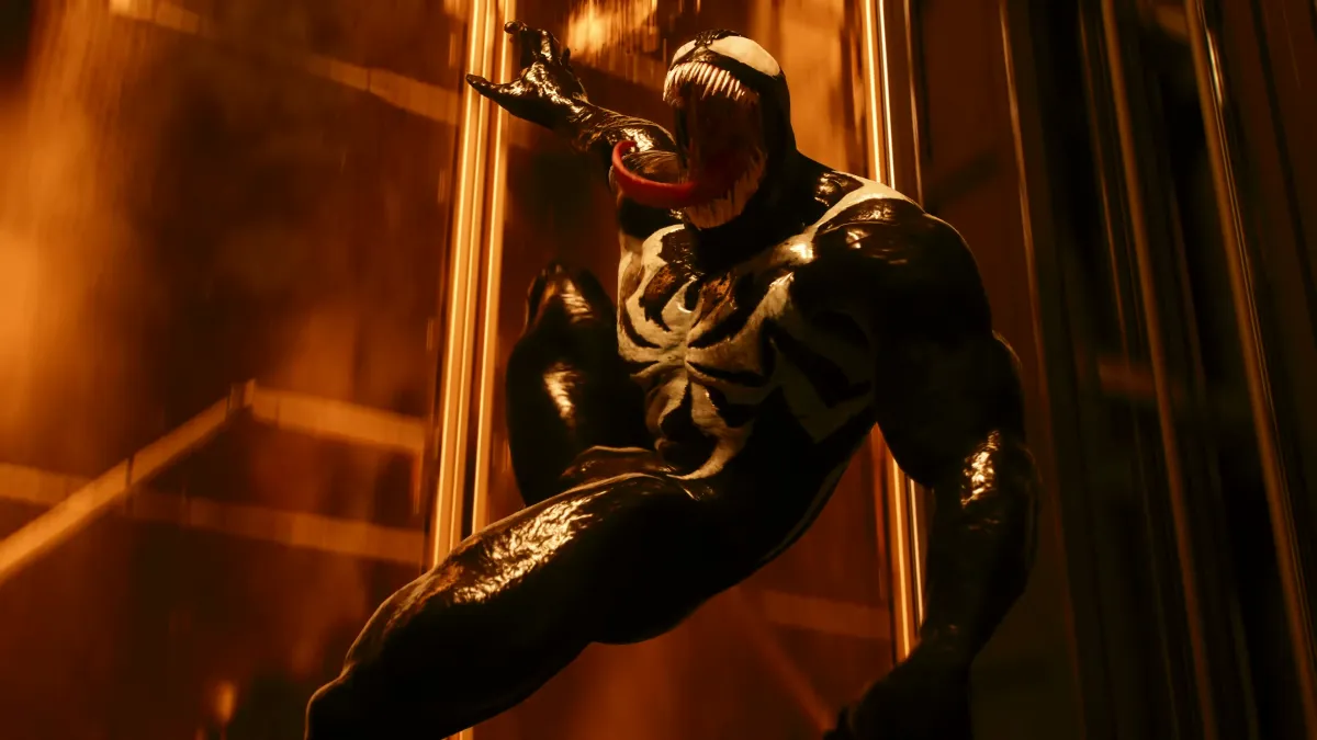 Venom in Marvel's Spider-Man 2, a humanoid creature, black and white patterns on its skin, with its toothy mouth open.
