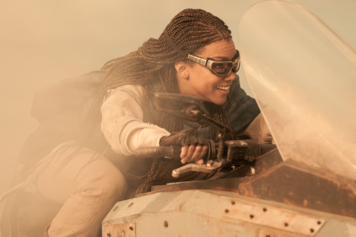 Burnham rides a speeder bike in the desert. This image is part of an article about Star Trek: Discovery Season 5, Episode 1 recap.