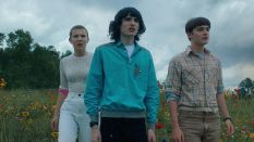 Mike, Eleven, and Will looking on in Stranger Things.