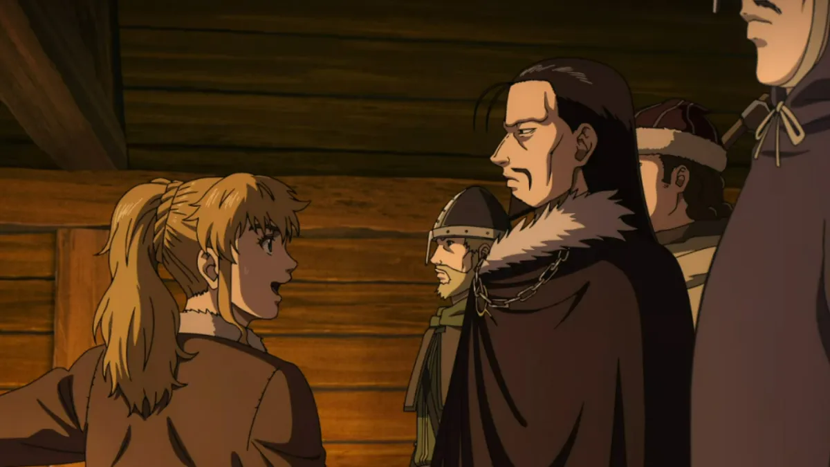 Vinland Saga, a girl pointing left while several men look on, in a medieval-style hut.