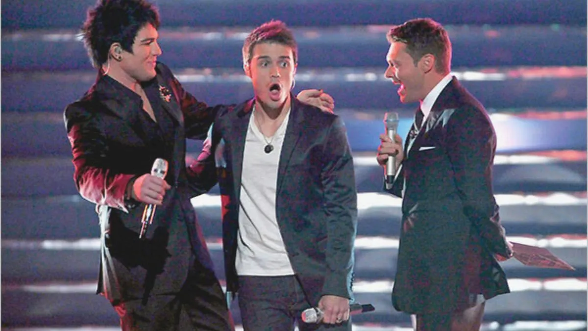 Adam Lambert, Kris Allen, and Ryan Seacrest on the stage of American Idol