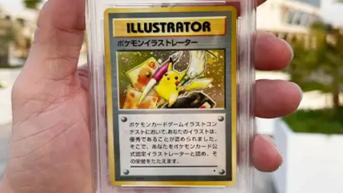 Photo of a hand holding up the PSA 10 Pikachu Illustrator Card