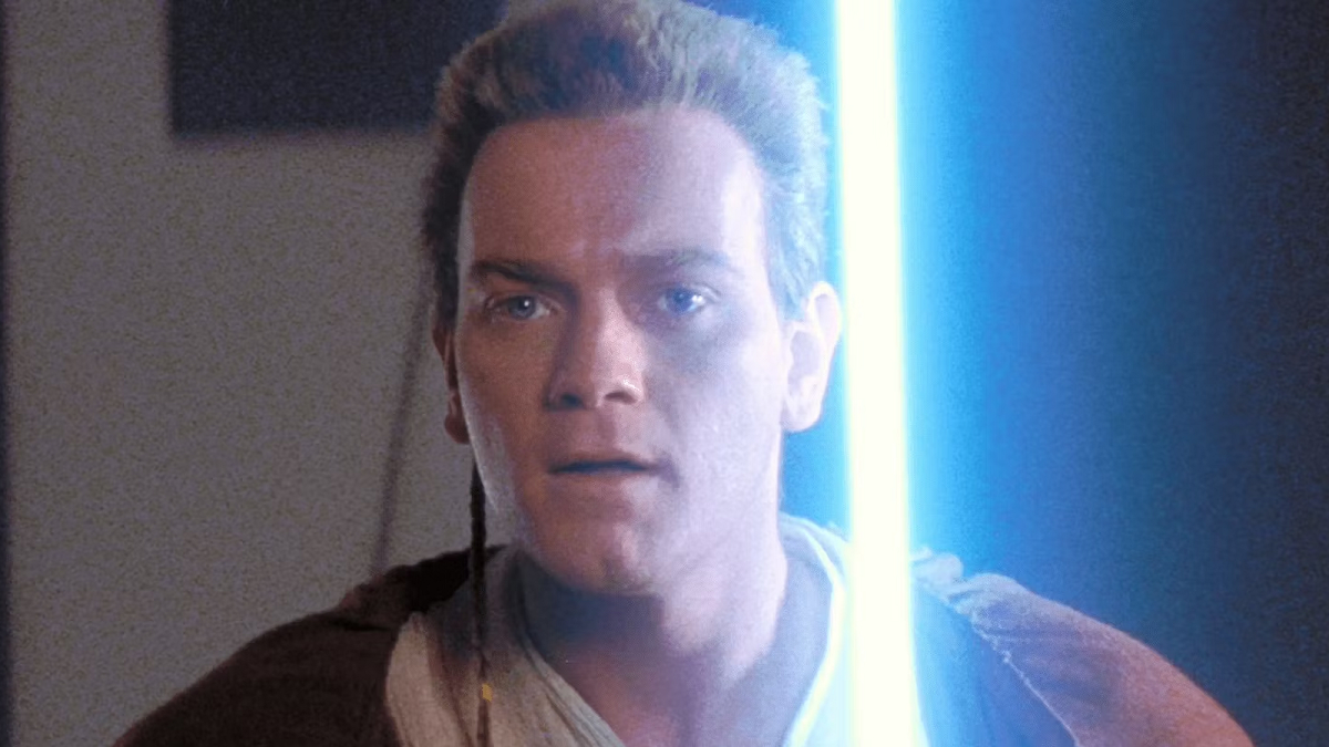 A close-up of Obi-Wan Kenobi brandishing his lightsaber in Star Wars: The Phantom Menace