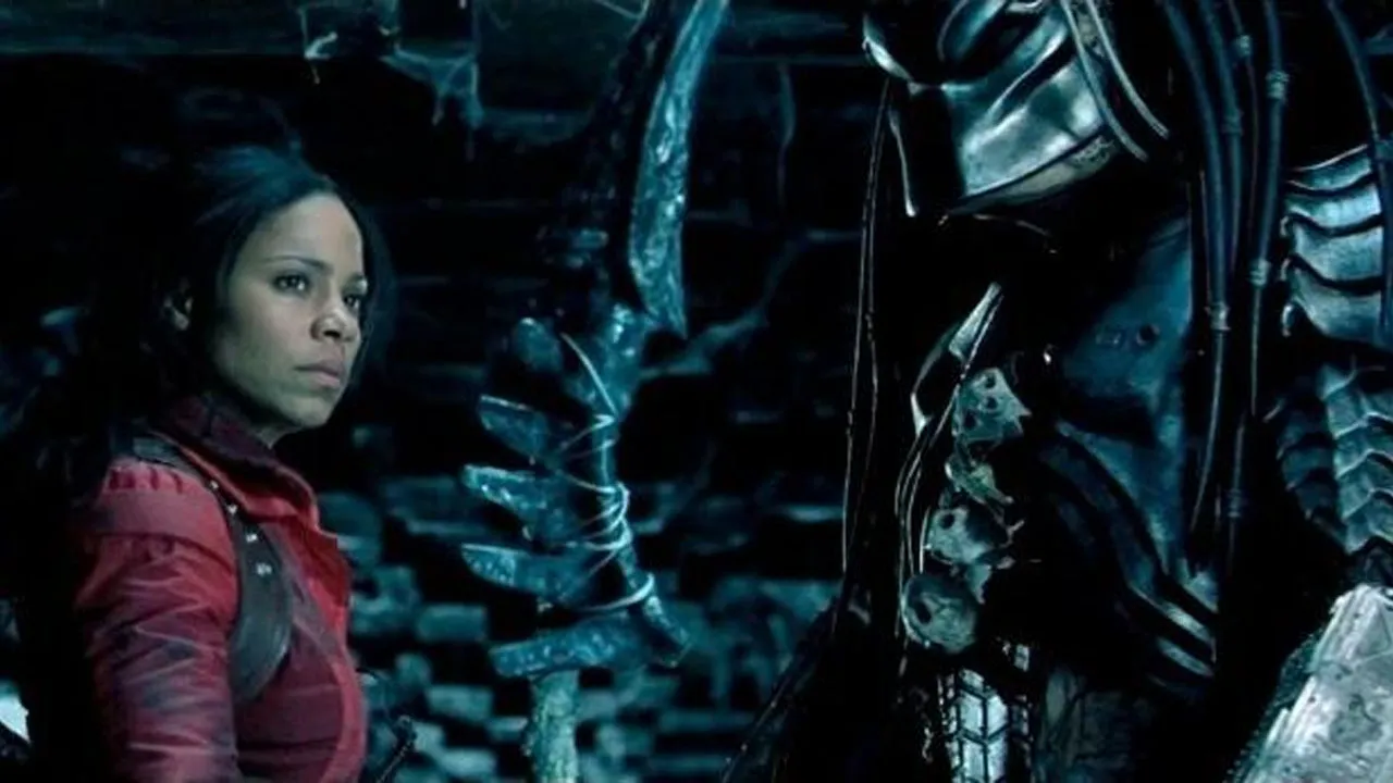 Alien vs Predator, a human woman in a red jacket standing next to a Predator.