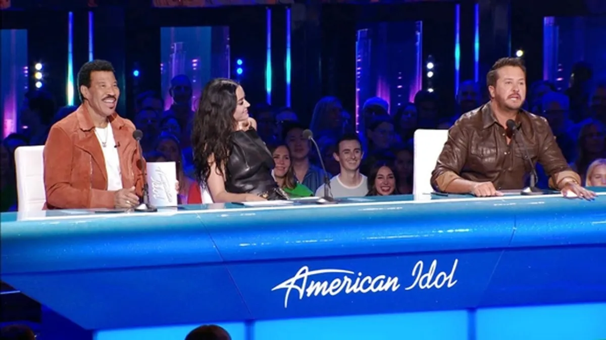 American Idol, three judges sitting at a blue desk.