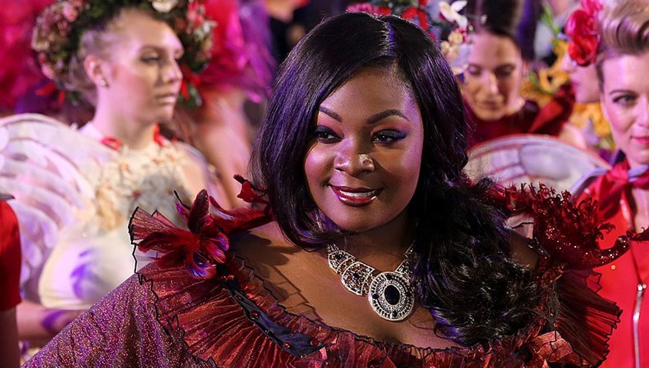 Candice Glover in an elaborate red and black dress. 