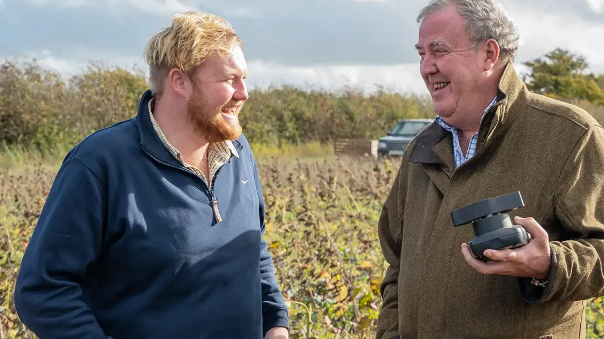 Jeremy Clarkson talking to a bearded man in Clarkson's Farm.