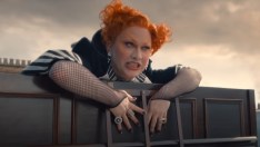 Jinkx Monsoon looking over a rooftop ledge
